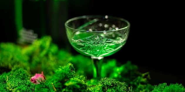 A glass that filled with Absinthe