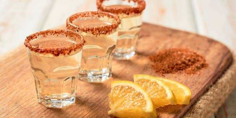 The image shows the 3 glasses of mezcal